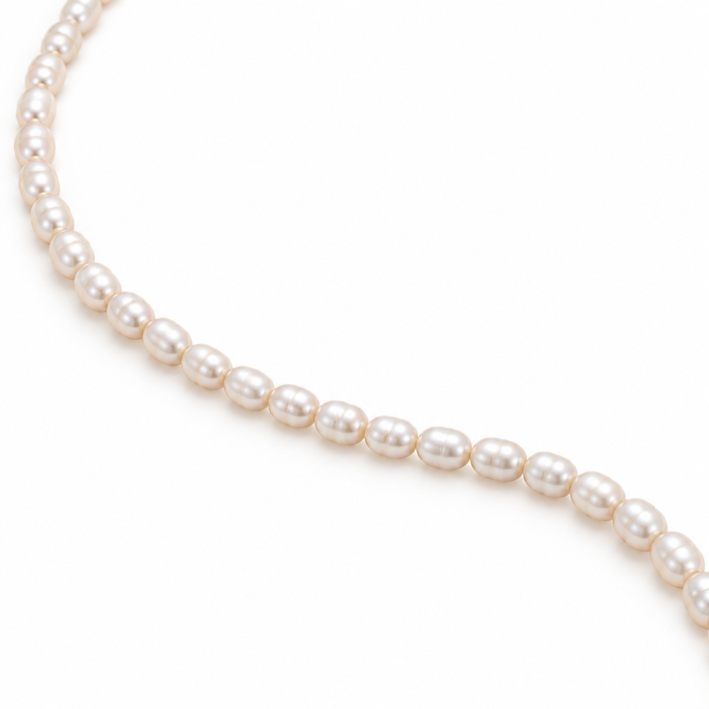 Signe Pearl Necklace with small cultured rice pearls, gold-tone 316L stainless steel details and a 5 cm extender